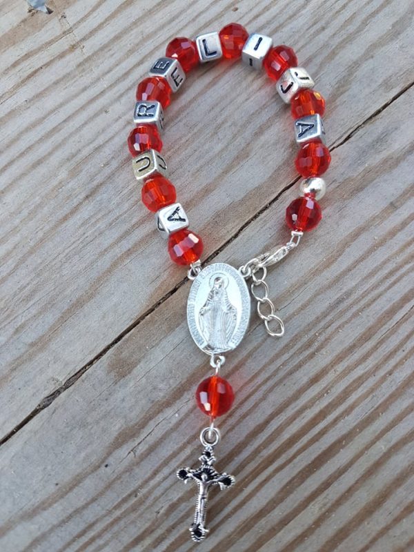 Raudonasis rožantelis krikšto